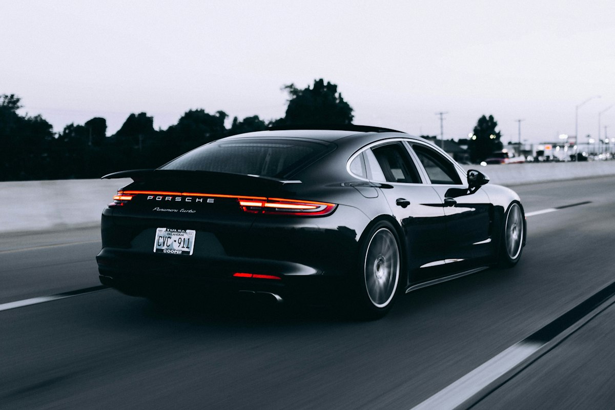 Photograph of a modern automobile driving on an open American road